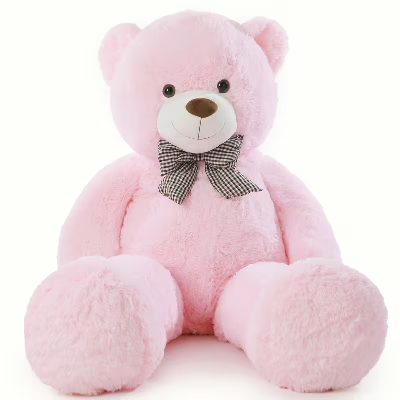 Pink teddy bear with a bow tie on a white background