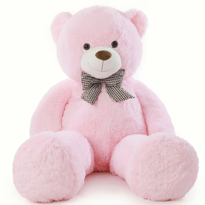 Pink teddy bear with a bow tie on a white background